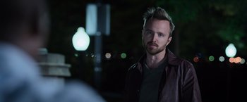 Movie still from “Central Intelligence” (2016), directed by Rawson Marshall Thurber – A man in a leather jacket standing in front of a street light; Close Up shot, Over the shoulder angle