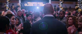 Movie still from “Central Intelligence” (2016), directed by Rawson Marshall Thurber – A group of people standing in front of a crowd; Medium shot, Over the shoulder angle