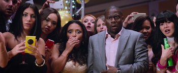 Movie still from “Central Intelligence” (2016), directed by Rawson Marshall Thurber – A group of people standing in front of each other at a party; Close Up shot, Low angle