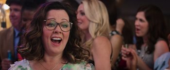 Movie still from “Central Intelligence” (2016), directed by Rawson Marshall Thurber – A woman wearing glasses and a green dress; Close Up shot, Overhead angle