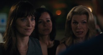 A group of women standing next to each other in front of lights