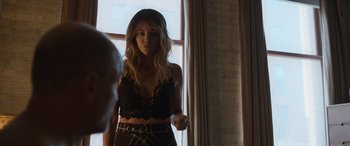 Movie still from “Champions” (2023), directed by Bobby Farrelly – A woman standing in front of a window in a room; Medium shot, Over the shoulder angle