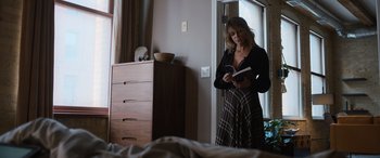 Movie still from “Champions” (2023), directed by Bobby Farrelly – A woman standing next to a bed reading a book; Medium shot, Low angle