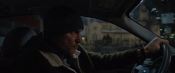 Movie still from “Champions” (2023), directed by Bobby Farrelly – A man sitting in the driver's seat of a car; Close Up shot, Low angle