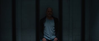 Movie still from “Champions” (2023), directed by Bobby Farrelly – A man sitting in front of a jail cell; Medium shot, Low angle