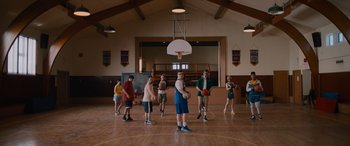 Movie still from “Champions” (2023), directed by Bobby Farrelly – A group of young people standing in a gymnasium; Wide shot, High angle