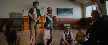Movie still from “Champions” (2023), directed by Bobby Farrelly – A group of people dressed up as basketball players; Wide shot, Low angle