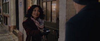 Movie still from “Champions” (2023), directed by Bobby Farrelly – A woman is holding a remote in her hand; Close Up shot, Over the shoulder angle