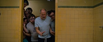 Movie still from “Champions” (2023), directed by Bobby Farrelly – A group of people standing in a bathroom next to each other; Medium shot, Low angle