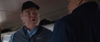 Movie still from “Champions” (2023), directed by Bobby Farrelly – A man in a hat and jacket talking to another man; Close Up shot, Over the shoulder angle