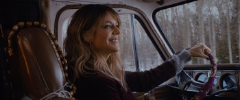 Movie still from “Champions” (2023), directed by Bobby Farrelly – A woman sitting in the driver's seat of a car; Close Up shot, Over the shoulder angle