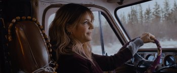 Movie still from “Champions” (2023), directed by Bobby Farrelly – A woman sitting in the driver's seat of a car; Close Up shot, Over the shoulder angle