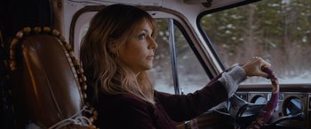 Movie still from “Champions” (2023), directed by Bobby Farrelly – A woman sitting in the driver's seat of a car; Close Up shot, High angle