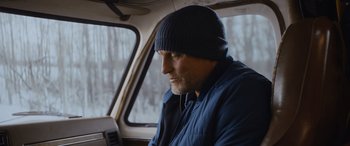 Movie still from “Champions” (2023), directed by Bobby Farrelly – A man wearing a blue jacket and a blue hat; Close Up shot, Low angle