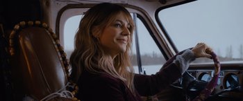Movie still from “Champions” (2023), directed by Bobby Farrelly – A woman sitting in the driver's seat of a car; Close Up shot, Over the shoulder angle