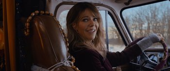 Movie still from “Champions” (2023), directed by Bobby Farrelly – A woman sitting in the back seat of a car; Close Up shot, Over the shoulder angle