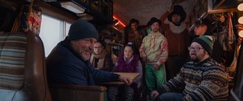 Movie still from “Champions” (2023), directed by Bobby Farrelly – A group of people sitting in a room together; Medium shot, Over the shoulder angle