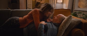 Movie still from “Champions” (2023), directed by Bobby Farrelly – A man and a woman laying on a couch together; Medium shot, High angle