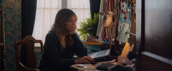 Movie still from “Champions” (2023), directed by Bobby Farrelly – A woman sitting in front of a laptop computer; Medium shot, Over the shoulder angle