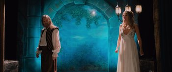 Movie still from “Champions” (2023), directed by Bobby Farrelly – Two women in medieval garb standing in front of a painting; Medium shot, Low angle