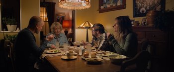 Movie still from “Champions” (2023), directed by Bobby Farrelly – A group of people sitting around a table eating; Medium shot, Over the shoulder angle