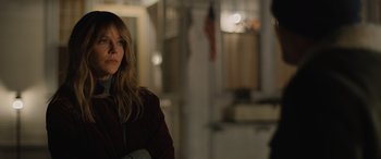 Movie still from “Champions” (2023), directed by Bobby Farrelly – A woman in a red jacket standing in a room; Medium shot, Over the shoulder angle