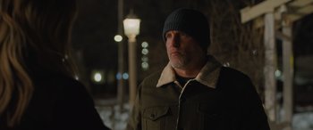 Movie still from “Champions” (2023), directed by Bobby Farrelly – A man wearing a green jacket and a blue hat; Close Up shot, Over the shoulder angle