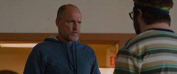 Movie still from “Champions” (2023), directed by Bobby Farrelly – A man in a blue hoodie looking to his left; Close Up shot, Over the shoulder angle