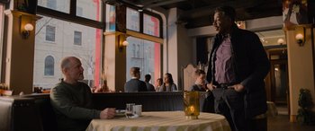 Movie still from “Champions” (2023), directed by Bobby Farrelly – People are sitting at a table in a restaurant; Medium shot, Over the shoulder angle