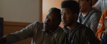 Movie still from “Champions” (2023), directed by Bobby Farrelly – Two men sitting next to each other in front of a window; Close Up shot, Over the shoulder angle