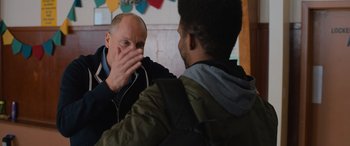 Movie still from “Champions” (2023), directed by Bobby Farrelly – Two men are talking to each other in a room; Close Up shot, Over the shoulder angle