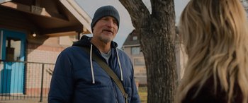 Movie still from “Champions” (2023), directed by Bobby Farrelly – A man wearing a blue jacket standing next to a tree; Medium shot, Low angle