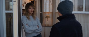 Movie still from “Champions” (2023), directed by Bobby Farrelly – A woman standing next to a man in a room; Medium shot, Over the shoulder angle