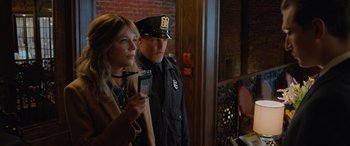 Movie still from “Champions” (2023), directed by Bobby Farrelly – A woman and a police officer standing next to each other; Medium shot, Over the shoulder angle