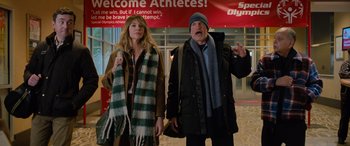 Movie still from “Champions” (2023), directed by Bobby Farrelly – A man and a woman standing next to each other in front of a building; Medium shot, Low angle