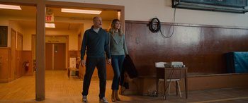 Movie still from “Champions” (2023), directed by Bobby Farrelly – A man and a woman holding hands while standing in a room; Medium shot, Low angle