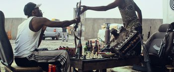 Movie still from “Chappie” (2015), directed by Neill Blomkamp – Two people are playing chess on an outdoor table; Medium shot, Over the shoulder angle