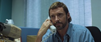 Movie still from “Chappie” (2015), directed by Neill Blomkamp – A person talking on a phone; Close Up shot, Over the shoulder angle