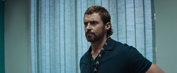 Movie still from “Chappie” (2015), directed by Neill Blomkamp – A person wearing a necklace; Close Up shot, Over the shoulder angle