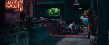 Movie still from “Chappie” (2015), directed by Neill Blomkamp – Two men sitting on the ground in a dark room; Extreme Wide shot, High angle