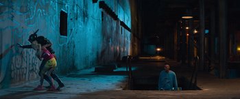 Movie still from “Chappie” (2015), directed by Neill Blomkamp – A man sitting on steps in a dark room; Extreme Wide shot, High angle