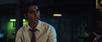 Movie still from “Chappie” (2015), directed by Neill Blomkamp – A man in a white dress shirt and a tie; Close Up shot, Over the shoulder angle