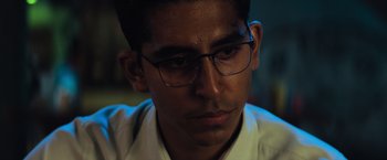 Movie still from “Chappie” (2015), directed by Neill Blomkamp – A person wearing glasses; Close Up shot, Over the shoulder angle