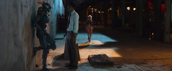 Movie still from “Chappie” (2015), directed by Neill Blomkamp – A man and a woman walking down a street at night; Wide shot, High angle