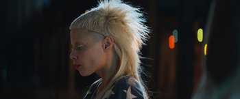 Movie still from “Chappie” (2015), directed by Neill Blomkamp – A person with a blonde mohawk hair style; Close Up shot, Low angle