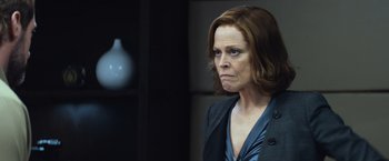 Movie still from “Chappie” (2015), directed by Neill Blomkamp – A person wearing a suit; Close Up shot, Low angle