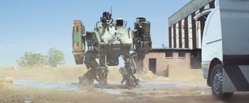 Movie still from “Chappie” (2015), directed by Neill Blomkamp – An image of a robot that is in the dirt; Extreme Wide shot, Low angle
