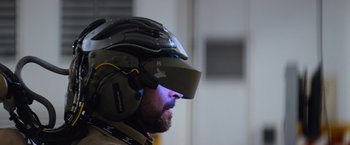 Movie still from “Chappie” (2015), directed by Neill Blomkamp – A man with a helmet on his head; Close Up shot, Over the shoulder angle
