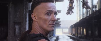 Movie still from “Chappie” (2015), directed by Neill Blomkamp – A person with a mohawk hair style; Close Up shot, Low angle