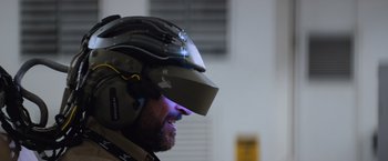 Movie still from “Chappie” (2015), directed by Neill Blomkamp – A man with a helmet on his head; Close Up shot, Over the shoulder angle
